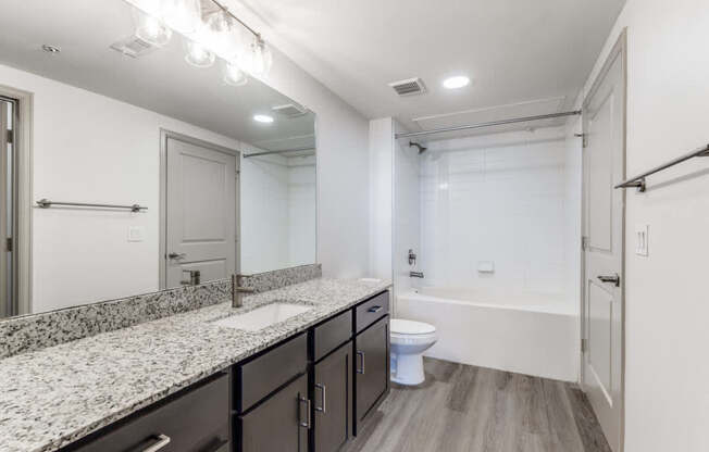 A bathroom with a toilet, sink, and bathtub.