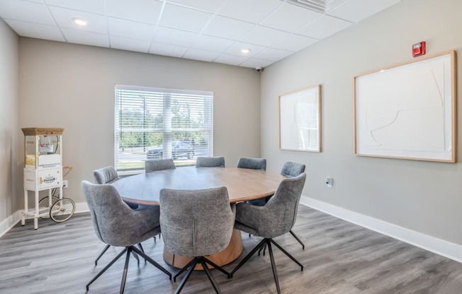 a conference room with a large table and chairs and a window