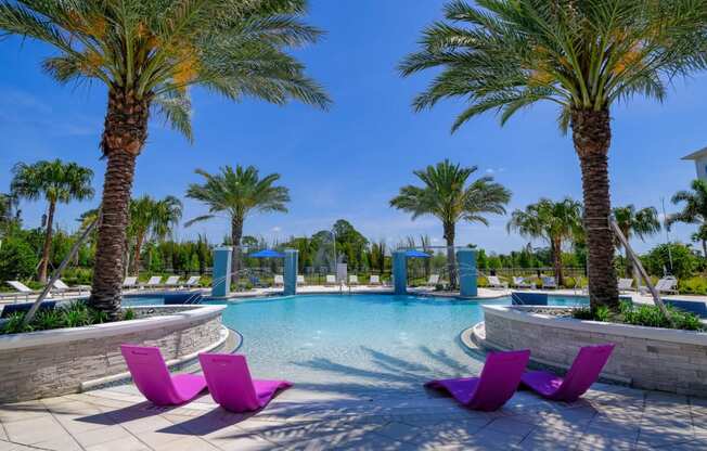 a large swimming pool with purple chairs and palm trees at Altis Grand Lake Willis, Orlando, FL