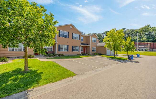 A large building with a parking lot in front.
