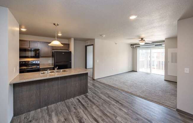 A modern kitchen with a bar area and a large open living space.