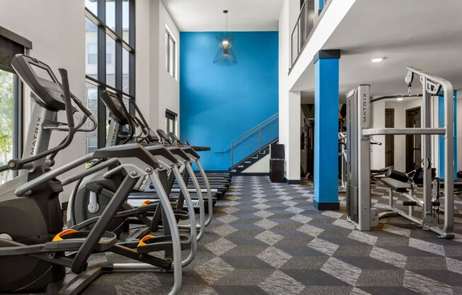 A gym with treadmills and exercise equipment.
