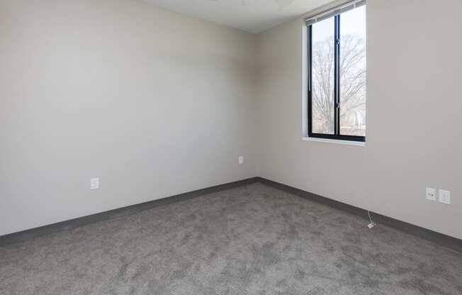 Spacious living room with neutral walls and ample natural light.