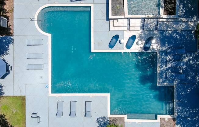 A swimming pool with a white fence and a white bench.