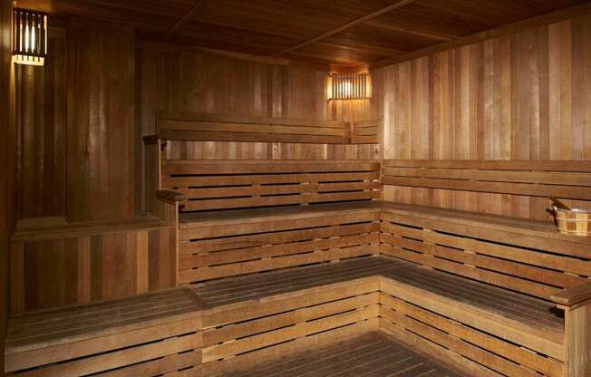 A wooden sauna with benches and lights.