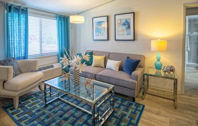 North Nashville Apartments - Retreat at Indian Lake - Living Room With Stylish Decor, White Walls, and a Large Window