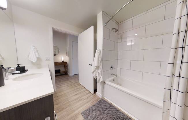 Upscale bathroom featuring large ceramic tile surround