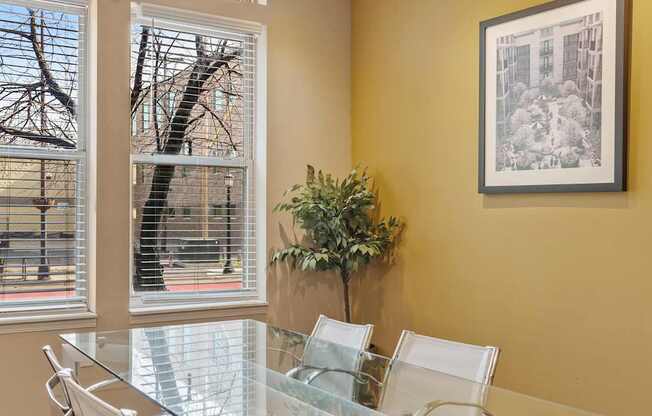 A conference room with a glass table and chairs.