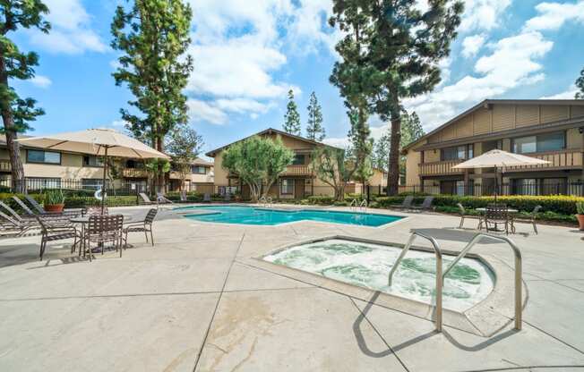 a swimming pool with chairs and umbrellas in front of a building