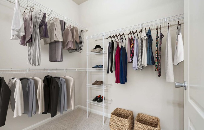 a closet with a rack of clothes in it and