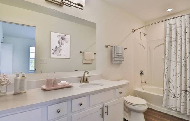 A white bathroom with a sink, toilet, and bathtub.