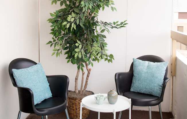 Balcony with outdoor seating arrangements at Hampton Plaza Apartments in Towson, MD 21286