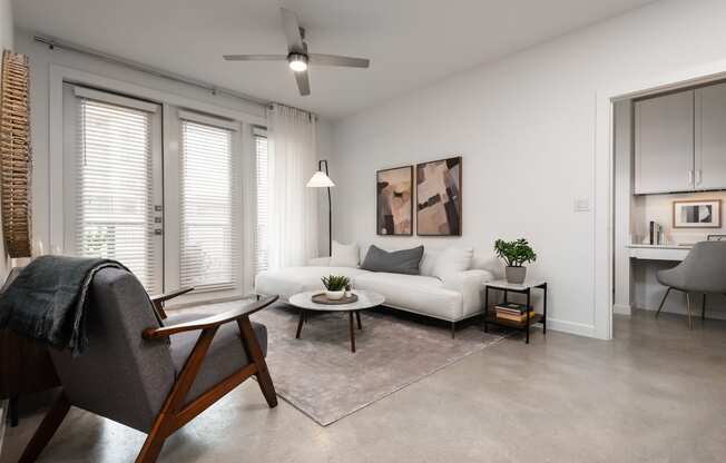 a living room with a white couch and a chair