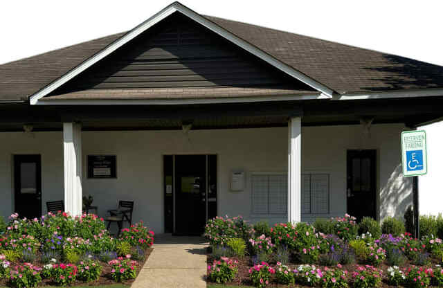 A building with a parking sign in front of it.