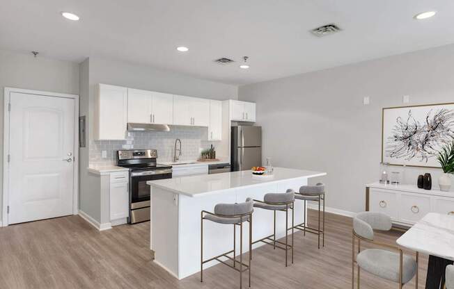 an open kitchen and dining area with a white island and stools