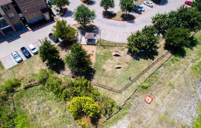 an aerial view of a yard with trees and a parking lot at Discovery at Craig Ranch, McKinney, TX, 75070