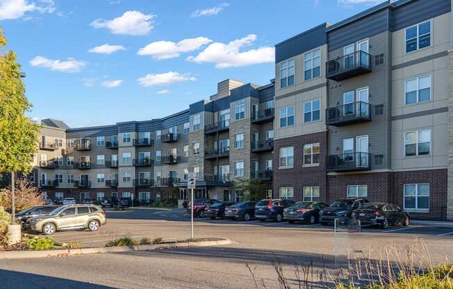 A parking lot in front of apartment buildings.