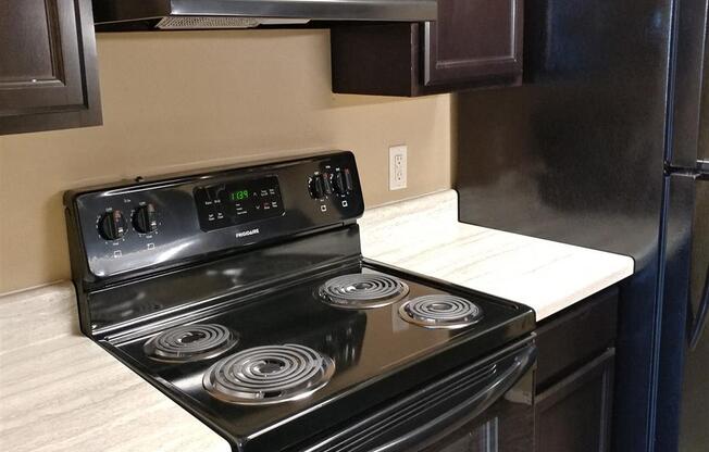 a kitchen with a stove and a refrigerator