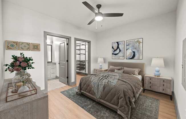 A bedroom with a bed, nightstands, and a ceiling fan.