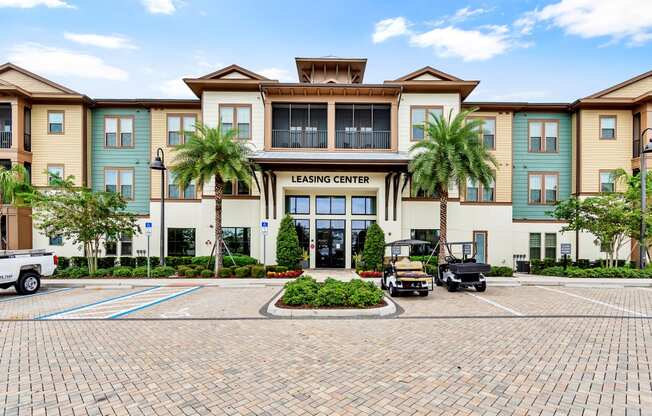 a large building with palm trees in front of it