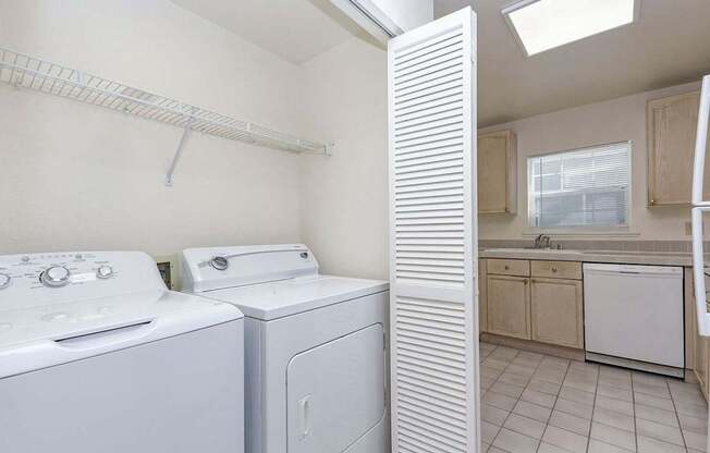 A white laundry room with a washer and dryer.