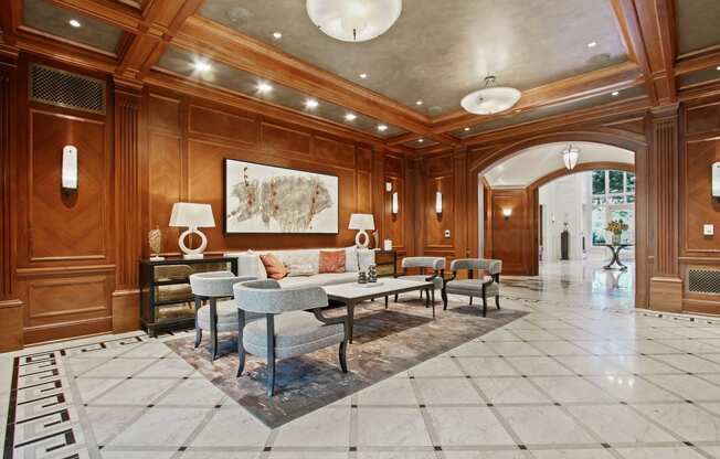 a living room with wood paneling and a large table and chairs