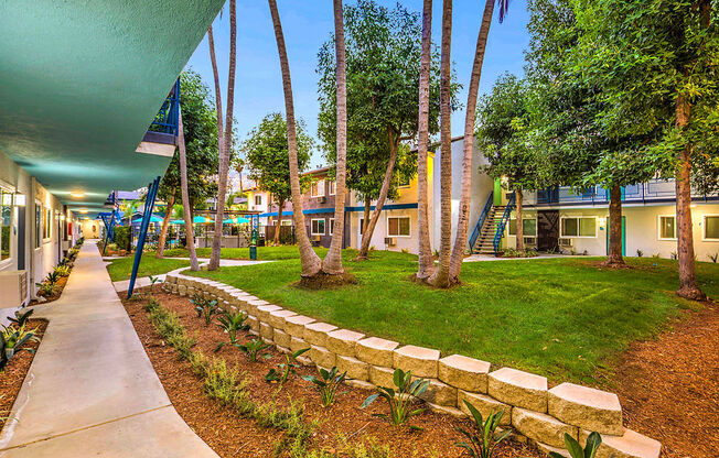 The Island Apartments courtyard grass lawn and palm trees