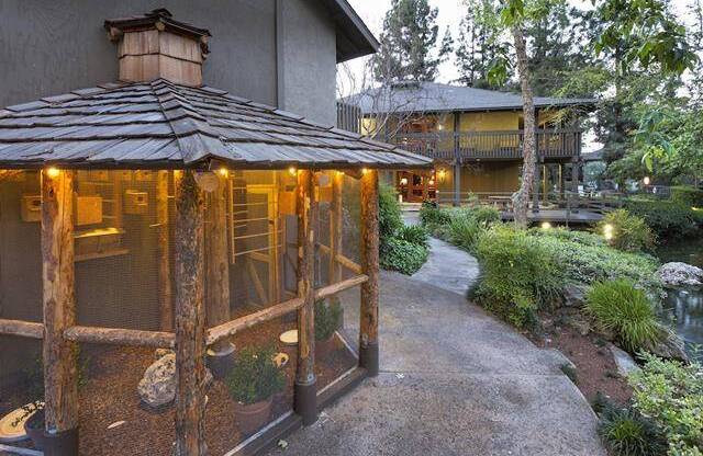 a bird aviary with lights at dusk