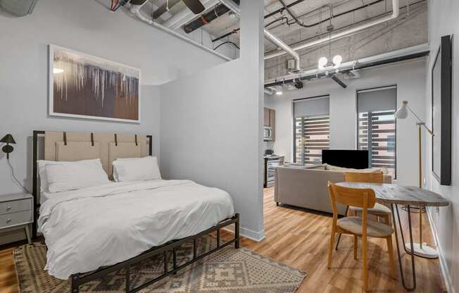 A bedroom with a bed, desk, and chair.