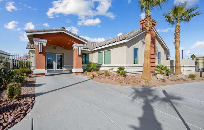 A house with a palm tree in front.
