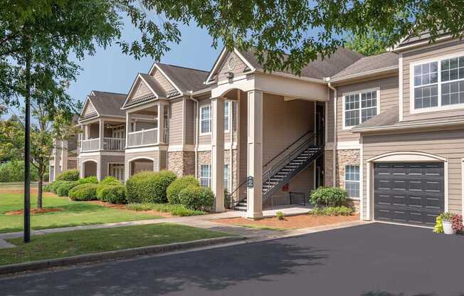 A large, two-story house with a garage and a driveway.