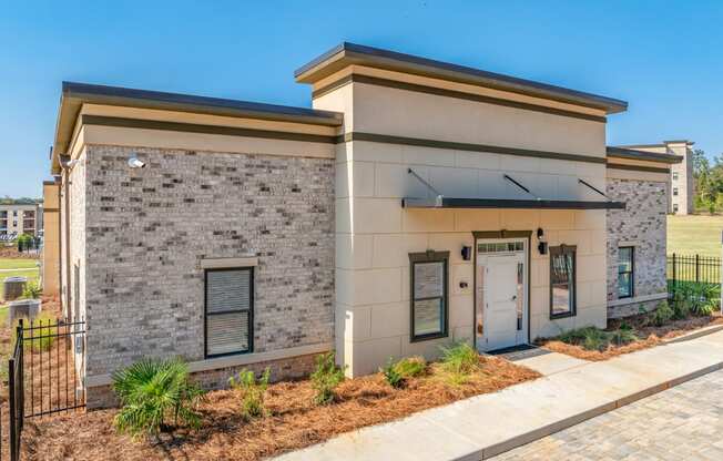 a building with a door and a sidewalk in front of it