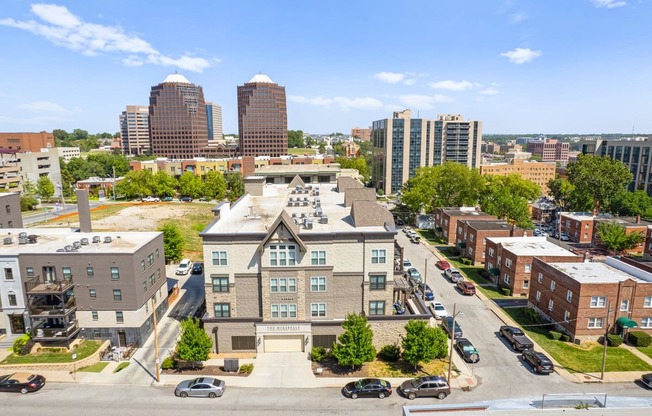 an aerial view of a large brick building in the middle of a city