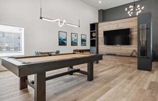 a games room with a pool table and a tv