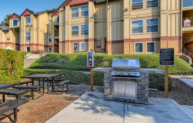 our apartments have a picnic area with a grill and tables