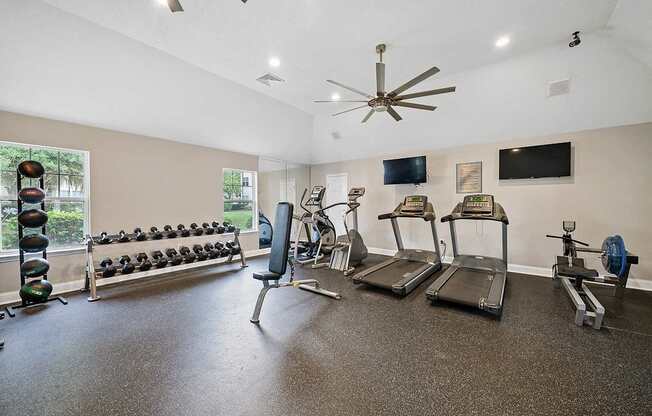 A spacious home gym with a variety of equipment including treadmills, weights, and exercise machines.