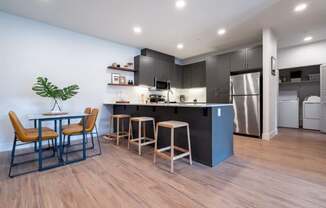 a kitchen and dining room with a table and chairs at Sonder Fields in Happy Valley, OR