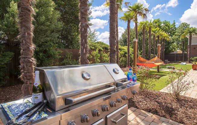 a barbecue grill in a backyard with palm trees