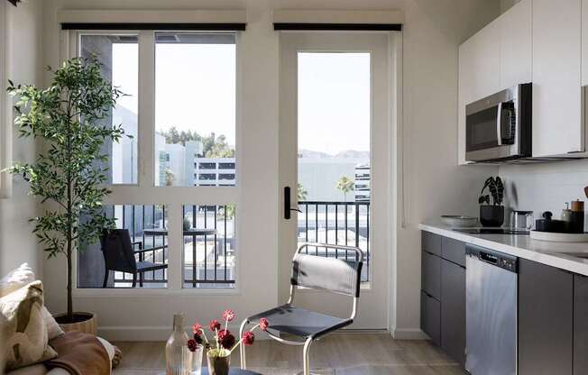 A modern kitchen with a chair and a table at Skylar At Sunset Apartments, California
