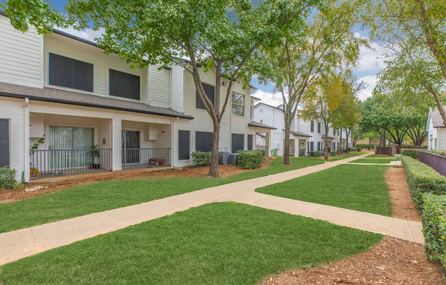 our apartments have a spacious courtyard with green grass and trees