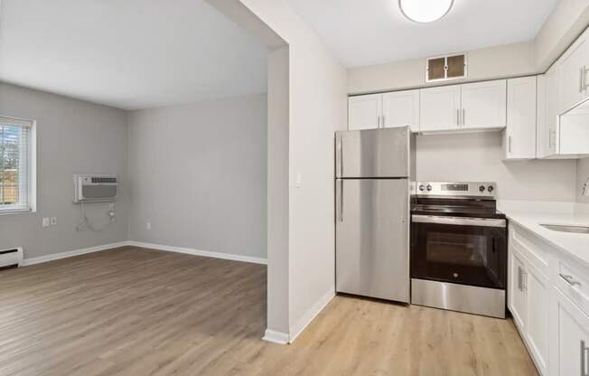A kitchen with a stainless steel refrigerator and oven.