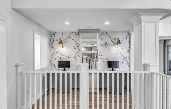 the entryway of a home with a white staircase and a wall with a wallpaper
