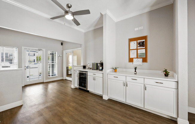 Bright and modern open-concept entryway featuring stylish cabinetry, sleek countertops, and elegant wood flooring, perfect for a welcoming living space.