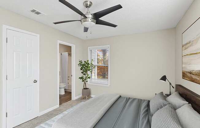 Model Bedroom with Carpet and Attached Bathroom at Element 41 Apartments located in Marietta, GA.