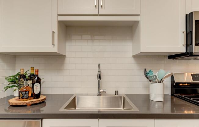 a kitchen with a stove a sink and a microwave