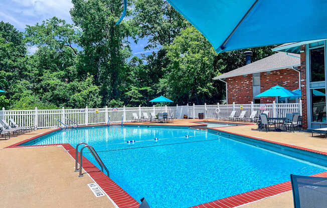 A large outdoor swimming pool with a red and white border.