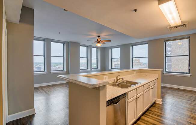 a kitchen with a large island and a ceiling fan