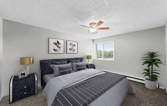 A bedroom with a large bed and a ceiling fan.