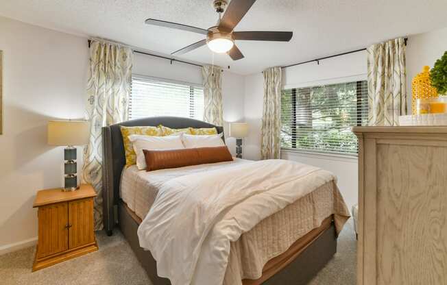 a bedroom with a bed and a ceiling fan