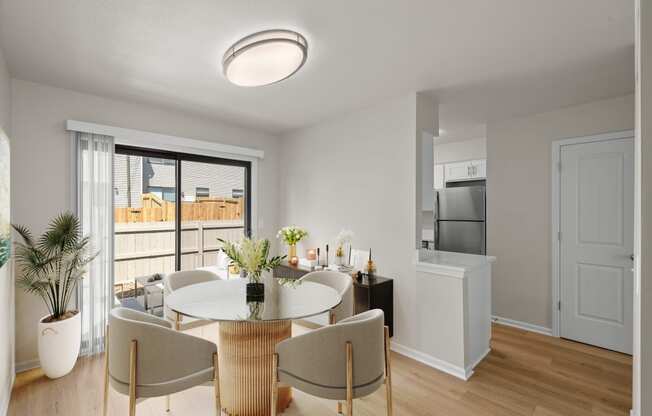 a living room and dining room with a table and chairs